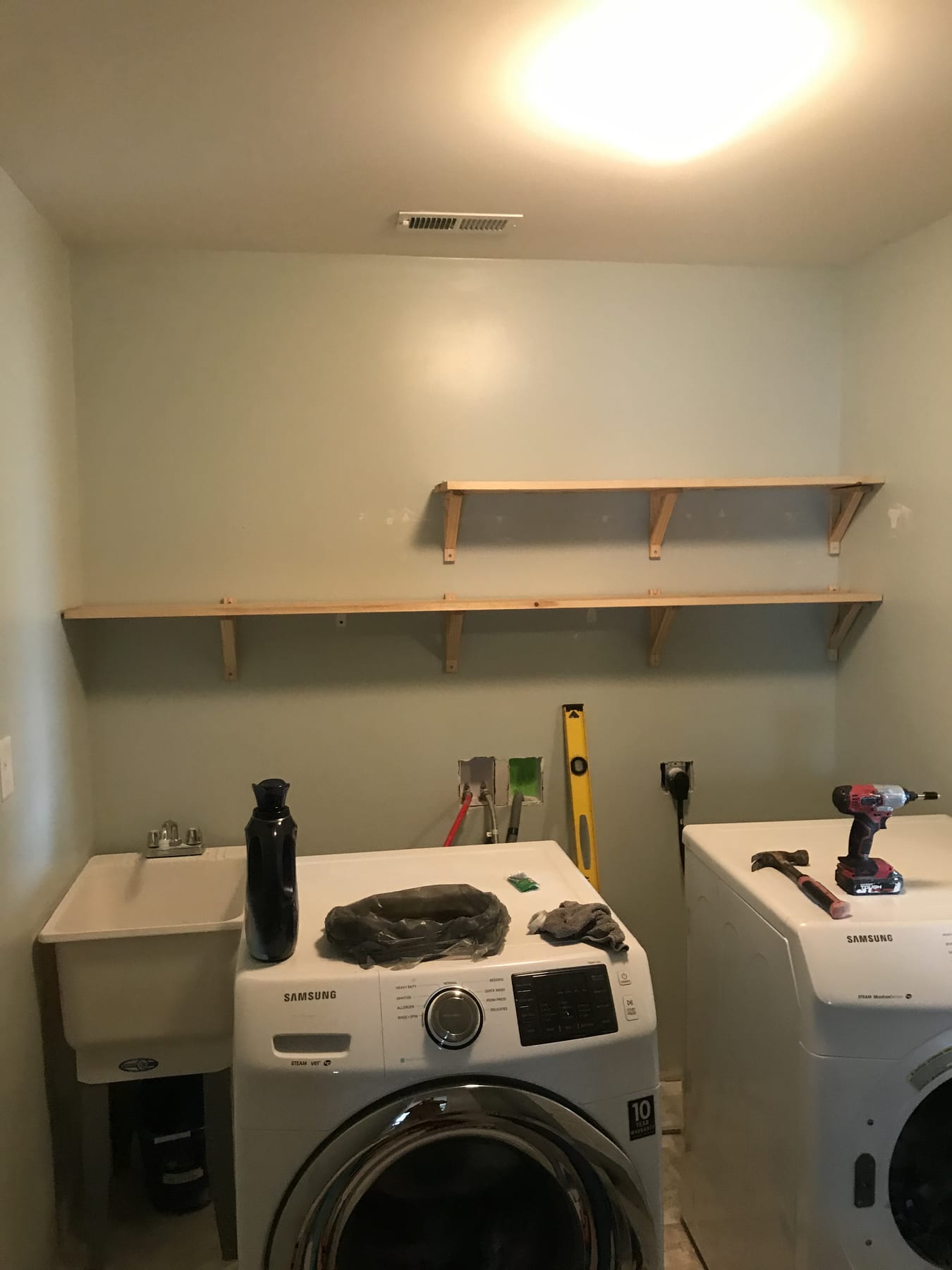 Built-in white shelving for a laundry room in a Kentucky home.