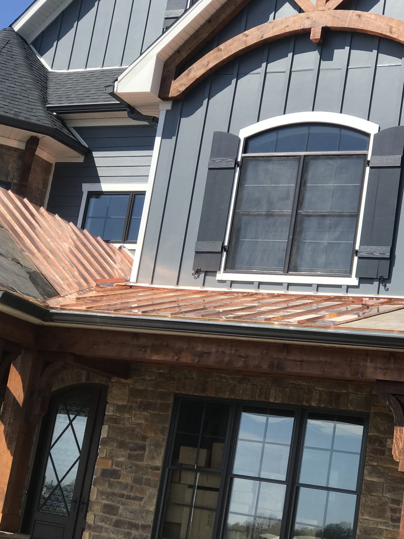 Cedar porch roof · Pulaski County, KY Cedar porch roof framing over a stone entry on a custom home in Pulaski County, KY.